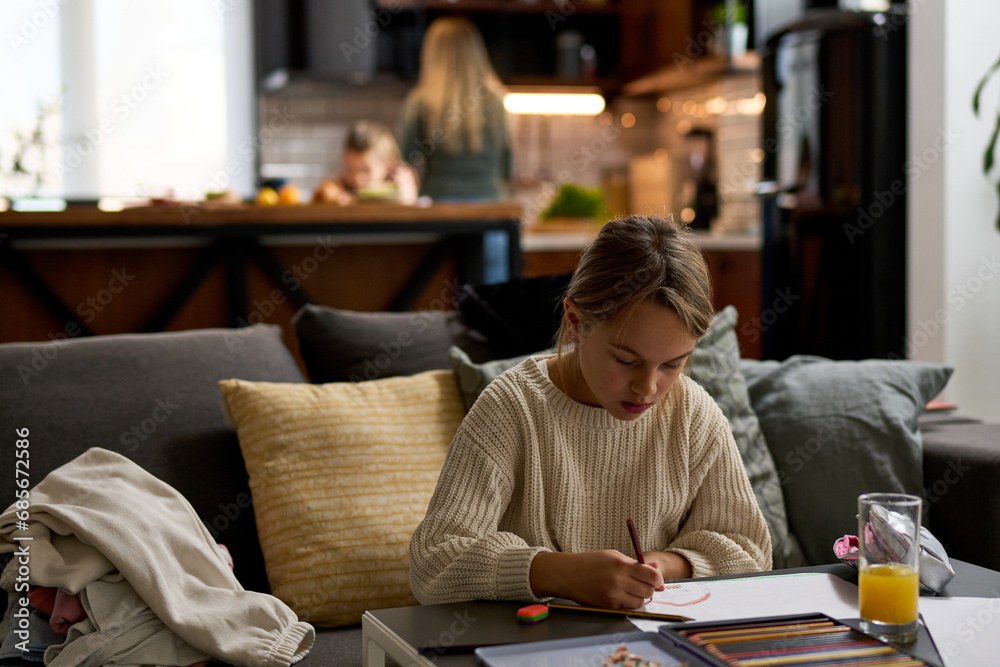 Portrait of a girl immersed in creativity, sketching away at a table in the living room, bringing art to life. Portrait of a girl immersed in creativity, sketching away at a table in the living room, bringing art to life.