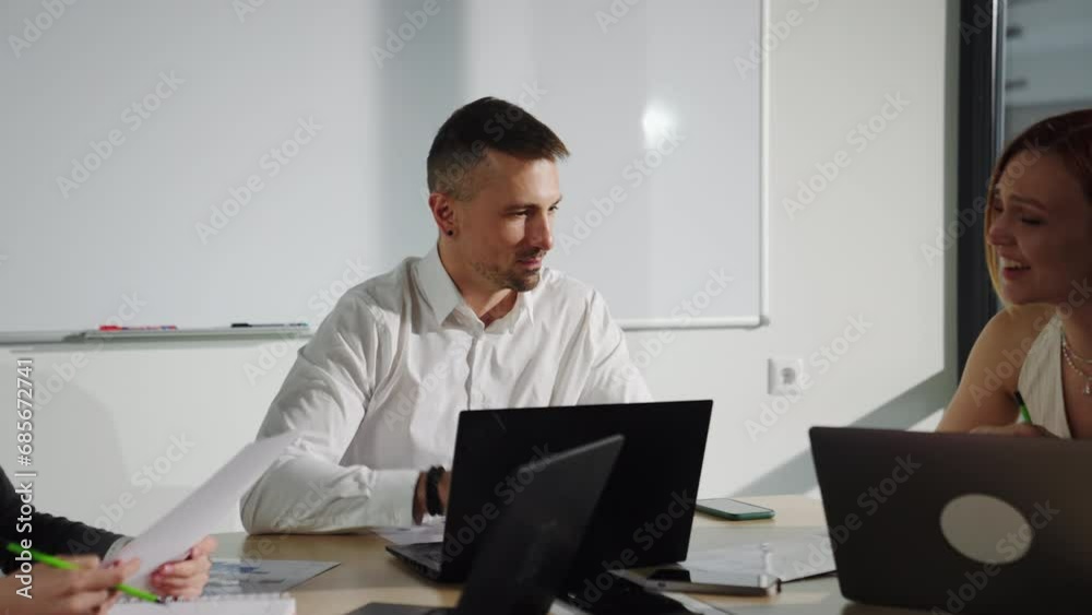 A man is the boss during a morning meeting with his colleagues. Good mood and positive communication A man is the boss during a morning meeting with his colleagues. Good mood and positive communication