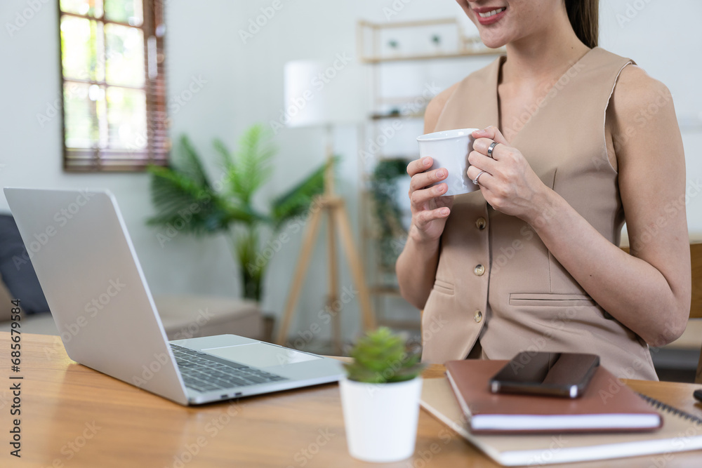 Beautiful happy Asian freelance woman using laptop computer for remote work at home She communicates with service providers to provide online real estate consultations. Beautiful happy Asian freelance woman using laptop computer for remote work at home She communicates with service providers to provide online real estate consultations.