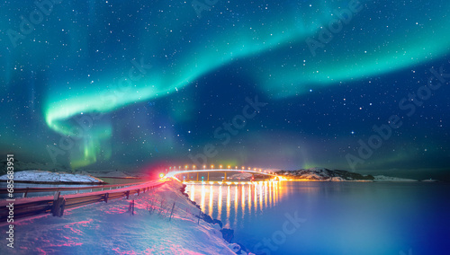 Sommaroy Bridge is a cantilever bridge connecting the islands of Kvaloya and Sommaroy with Aurora Borealis - Hillesoy Tromso Norway photo