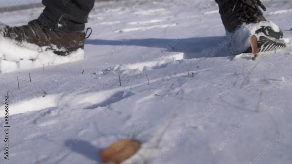 feet walking in deep snow shot in slow motion