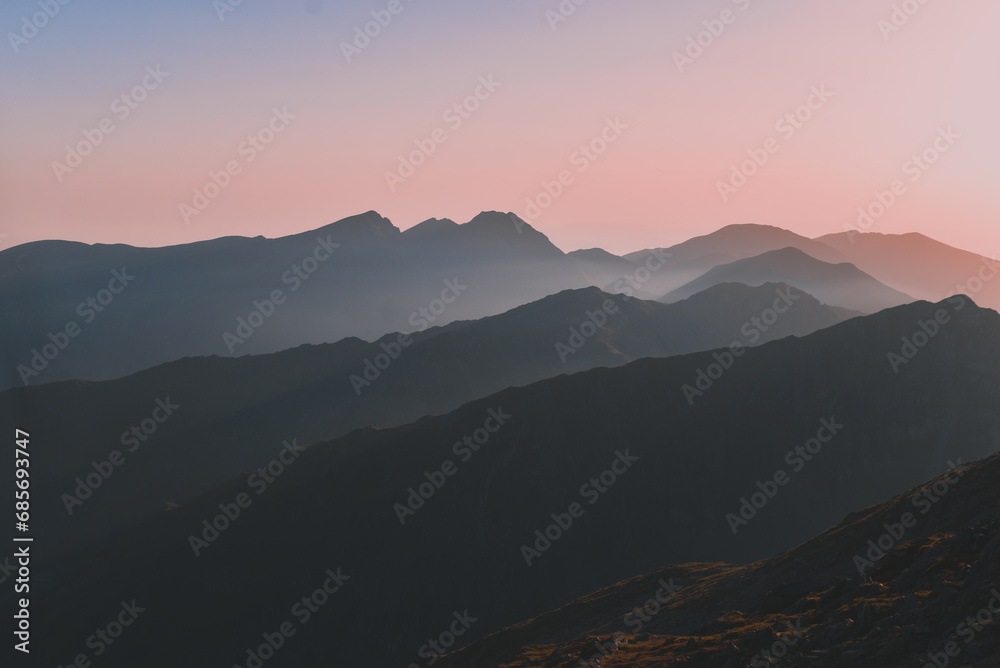 Sharp mountain peaks seen in stunning light from high altitude. Fairy tale landscape with wild Carpathians