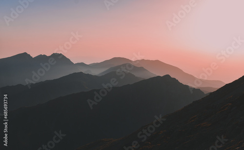 Sharp mountain peaks seen in stunning light from high altitude. Fairy tale landscape with wild Carpathians photo