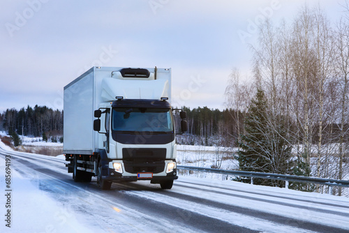 White Refrigerated Delivery Truck on Winter Road