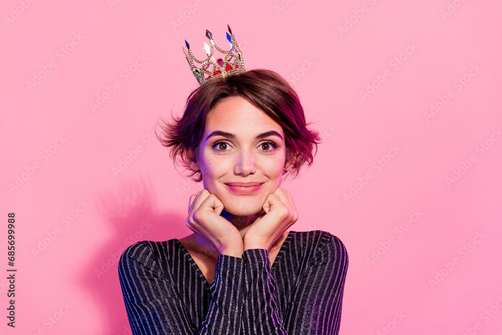 Photo of excited sweet girl dressed glamour clothes tiara arms cheeks smiling isolated pink color background