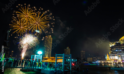 Colorful fireworks light up a riverside hotel, firework display in the heart of Bangkok on Loy Krathong Day in the middle of the Chao Phraya River, Bangkok, Thailand on November 27, 2023.