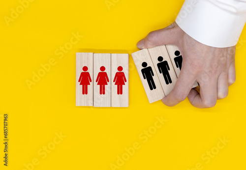 Opposite of man and woman icon on wooden block cube on blue and pink background. Man and woman quite different thinking and behaviour.
