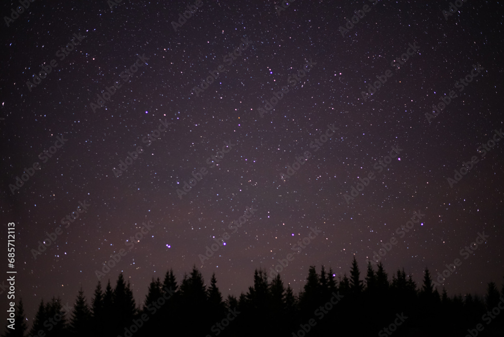 Night details with the sky full of stars observed from an wild place on Earth. The universe illuminated by infinite brilliance. Meteor showers during the summer