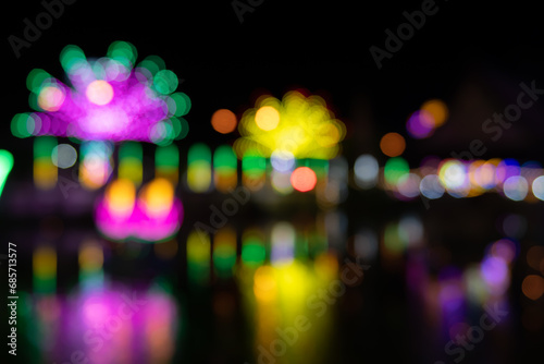 blur of colorful lights in an outdoor amusement park at night. The temple fair is an annual tradition. There is a place for religious ceremonies. and local amusement parks
