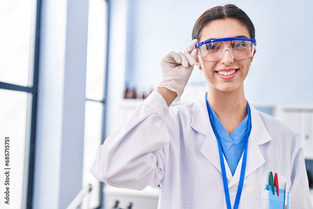 Young beautiful hispanic woman scientist smiling confident standing at laboratory Young beautiful hispanic woman scientist smiling confident standing at laboratory
