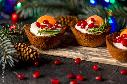 Christmas nut tartlets. Delicious, beautiful cupcakes are decorated with Christmas garlands and Christmas tree branches. Selective focus