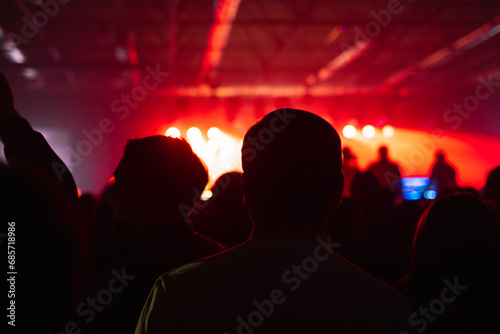 rock concert, music festival, New Year celebration, nightclub party, dance floor, disco club, many people standing with their hands up and clapping, happiness and nightlife concept