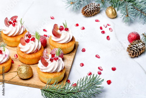 Traditional Christmas cottage cheese cupcakes. Decorated with fir branches and Christmas decorations. Copy space. High key