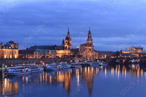 Dresden skyline during the blue hour, showing building reflections on the Elbe river and boats nearby