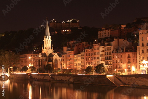 Church and buildings by night in the Saint Georges District in Lyon, France photo