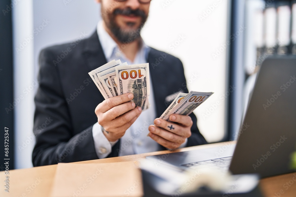 Young bald man business worker counting dollars at office Young bald man business worker counting dollars at office