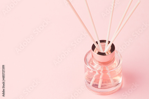 Bottle of room fragrance on a pink background photo