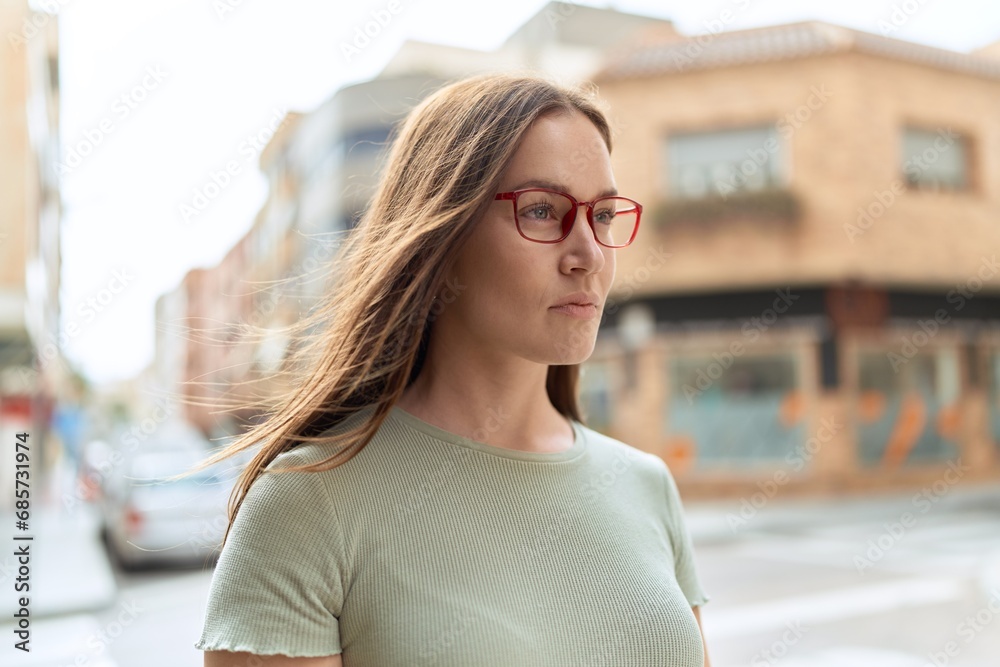 Young beautiful woman wearing glasses at street