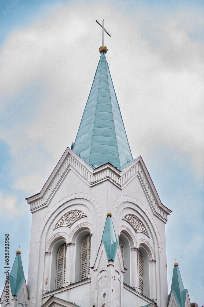 Gold christian cross shining in the top of a bright blue tower orthodox church in Latvia, Riga Gold christian cross shining in the top of a bright blue tower orthodox church in Latvia, Riga