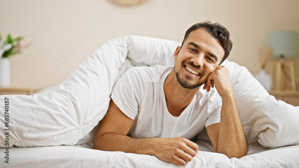 Young hispanic man smiling confident lying on bed at bedroom Young hispanic man smiling confident lying on bed at bedroom