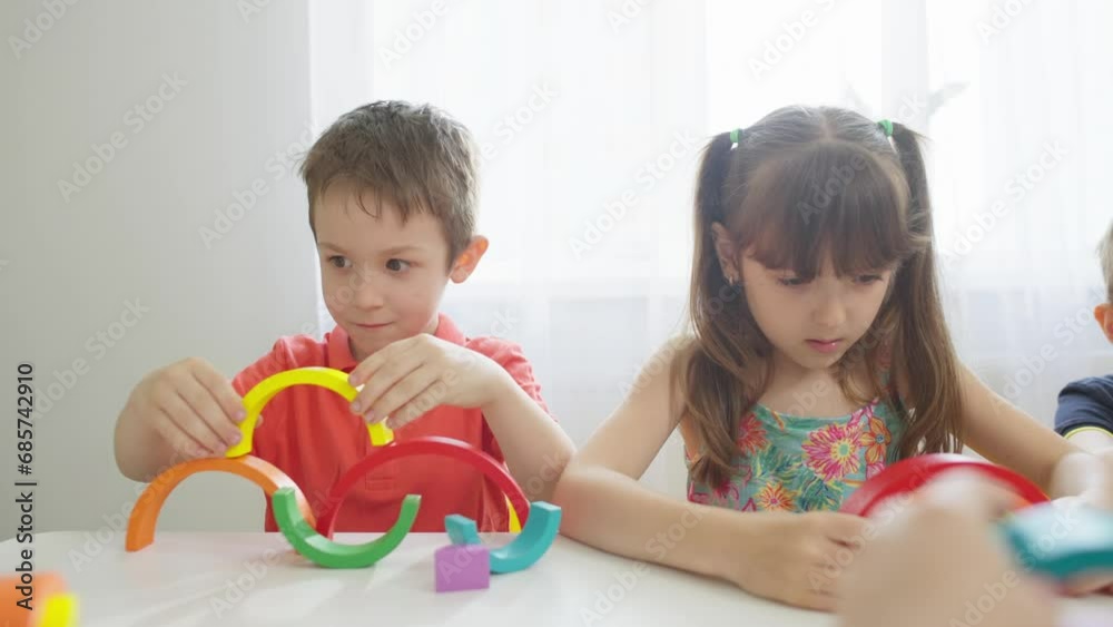 Close-up of a boy making a rainbow of different colors in a kindergarten. Classes and teaching children to study colors. High quality 4k footage Close-up of a boy making a rainbow of different colors in a kindergarten. Classes and teaching children to study colors. High quality 4k footage