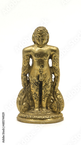 golden jain bahubali statue from a handcrafted collection from an antique shop isolated in a white background photo