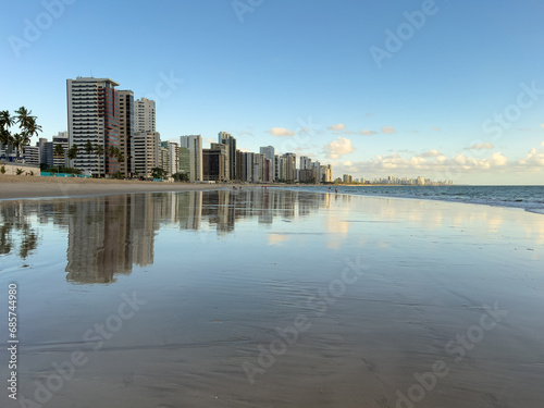 Apartment Buildings are mirroring at the Beach of Candeias and Piedade  early in the morning  just after sunrise. The City of Recife  Brazil is to see in the background. Jaboatao dos Guararapes