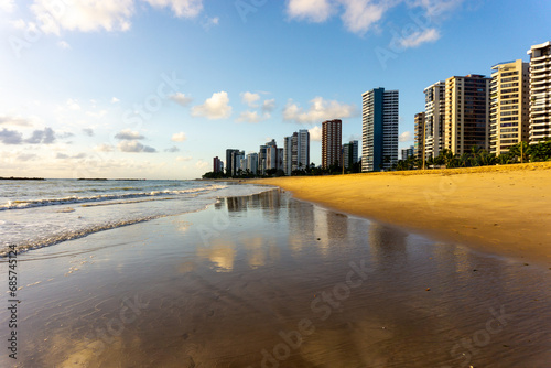Apartment Buildings are mirroring at the Beach of Piedade  early in the morning, just after sunrise. Jaboatao dos Guararapes, Pernambuco photo