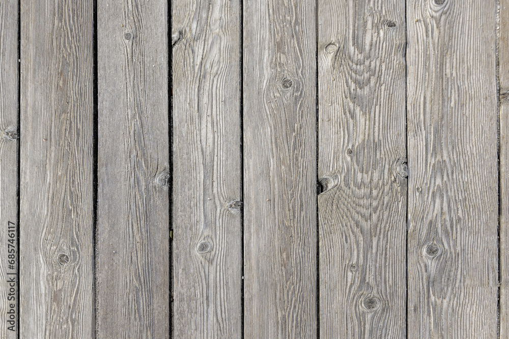 A grayish unvarnished wooden plank floor with grains of sand on the surface. Vector wood texture background