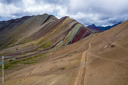 Hiking trail towards Vinicunca in Cusco, Peru with an elevation of over 17,000 ft. The landscape is known as Rainbow Mountain or Montana de Siete Colores.