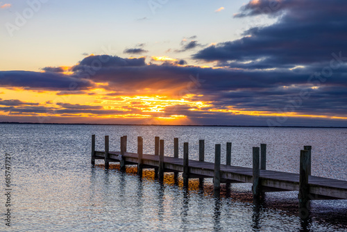 Colorful Sunrise On A Bay In NJ With Dock In The Foreground 