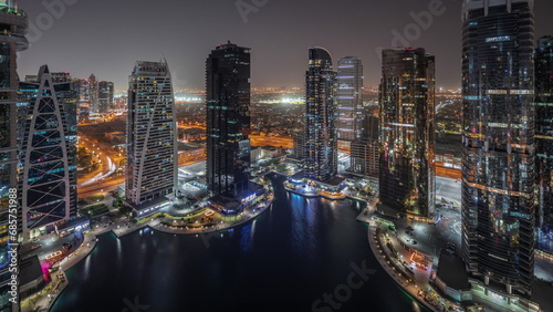 Tall residential buildings at JLT aerial night timelapse, part of the Dubai multi commodities centre mixed-use district. © neiezhmakov