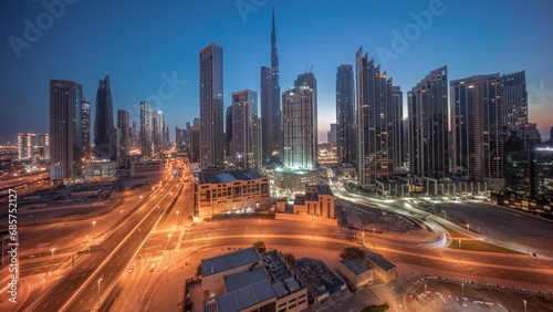 Aerial view of Dubai Downtown skyline with many towers night to day timelapse.