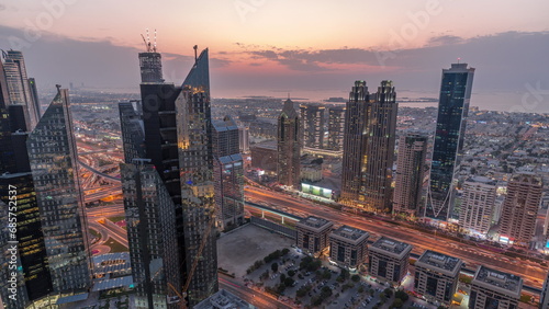 High-rise buildings on Sheikh Zayed Road in Dubai aerial day to night timelapse, UAE.