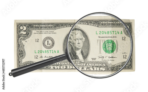 Two dollar bill under zooming of magnifying lens on white background