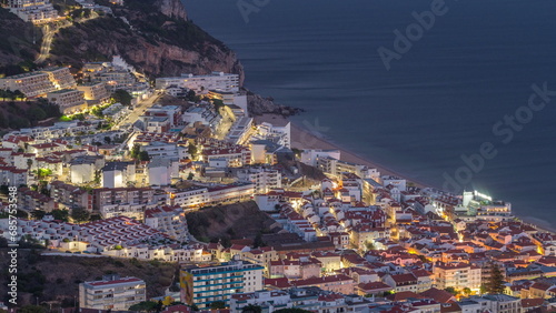 Bild auf Leinwand Aerial view of the coastline of the village of Sesimbra day to night timelapse