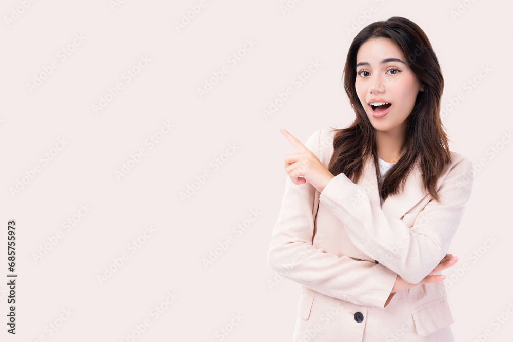 Beautiful young business woman pointing up to copy space and looking at camera with smile face and happy Pretty girl act like a satisfied product, use for advertising with isolated on pink background Beautiful young business woman pointing up to copy space and looking at camera with smile face and happy Pretty girl act like a satisfied product, use for advertising with isolated on pink background