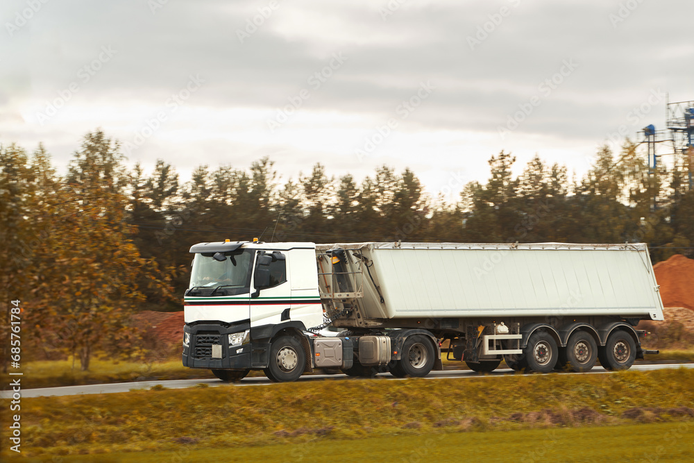 Cargo truck on the mountain highway. Delivery truck on the Europe motorway. Global delivery concept. Cargo truck on the mountain highway. Delivery truck on the Europe motorway. Global delivery concept.