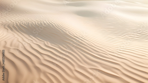 Rippled sand texture on a beach with subtle light and shadow play. © Hans