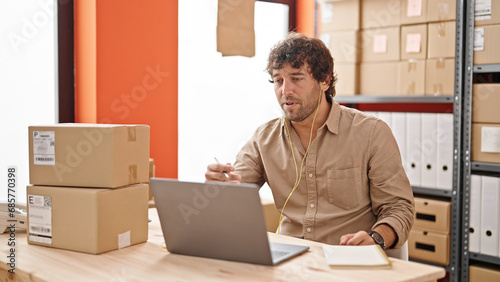 Young hispanic man ecommerce business worker having video call at office