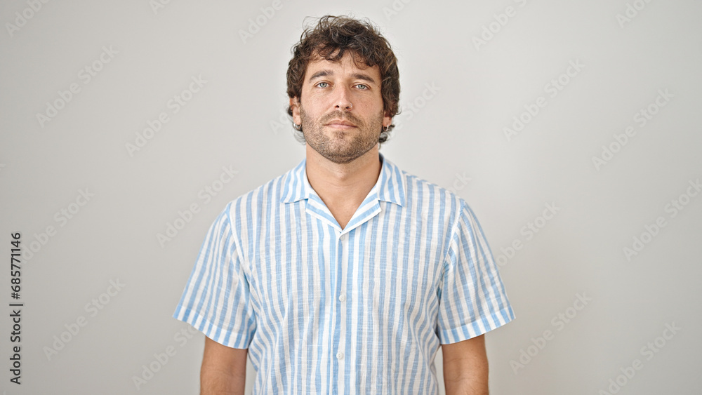 Young hispanic man standing with serious face over isolated white background Young hispanic man standing with serious face over isolated white background