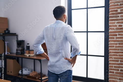 Young arab man business worker looking throw the window at office