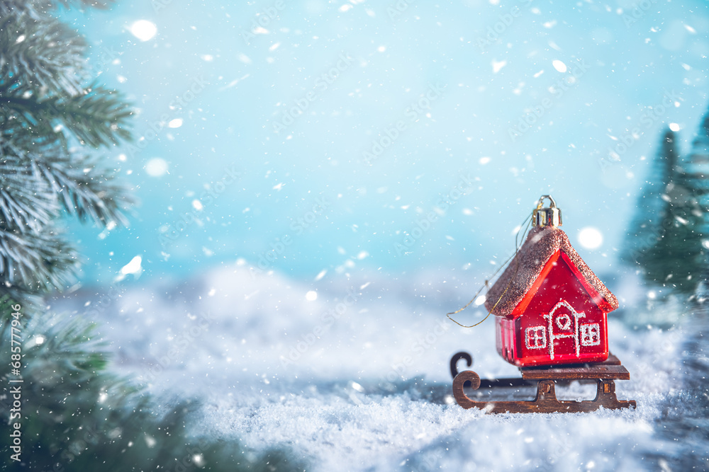 Christmas tree toy in the form of a red house on a sleigh in the snow. christmas, new year background Christmas tree toy in the form of a red house on a sleigh in the snow. christmas, new year background
