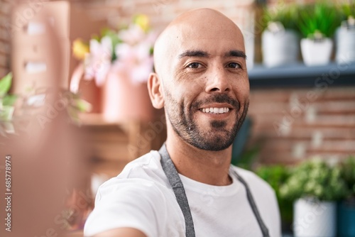 Young bald man florist smiling confident make selfie by camera at florist