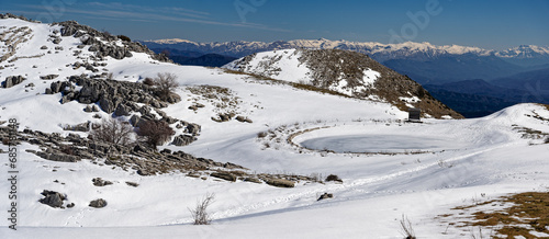 Panoramic winter landscape with frozen lake at Mount Avgerinos in Epirus, Greece © dinosmichail