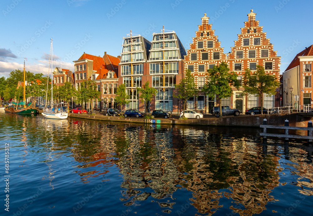 Traditional Dutch architecture reflected in water, Haarlem canals, Netherlands