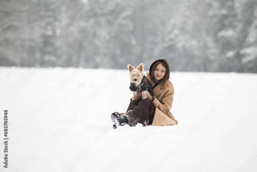 Fototapeta premium Portrait of a young beautiful girl in a winter forest.
