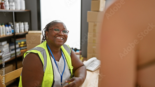 Bilde på lerret Heartwarming, african american woman with braids joyfully volunteering, sitting