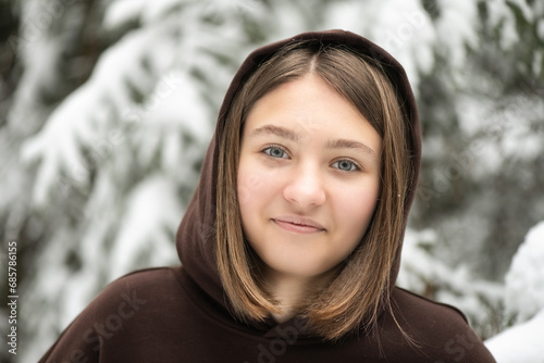 Portrait of a young beautiful girl in a winter forest.