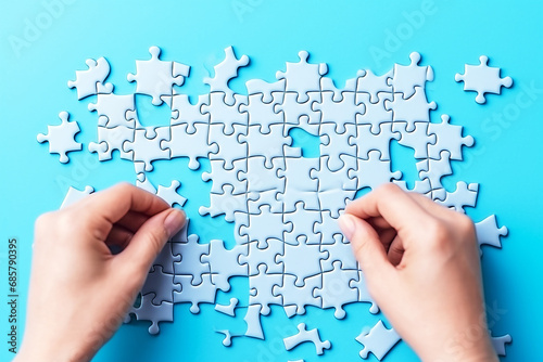 Jigsaw puzzle game on blue background with thinking concept